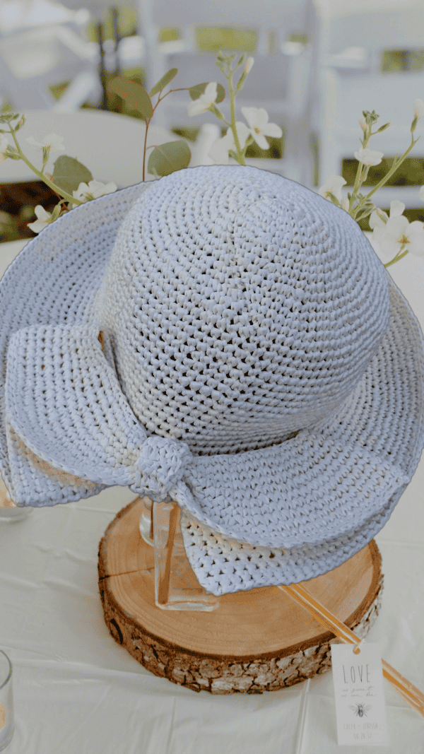 Un chapeau élégant crocheté à la main en raphia 100 % fibres naturelles de bois, idéal pour sublimer vos tenues estivales et apporter une touche glamour en cette période de fête.